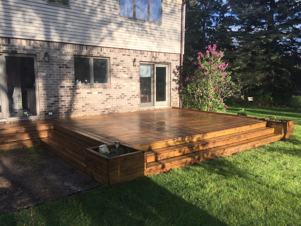 Exterior Painters in Ann Arbor showcase a newly stained deck